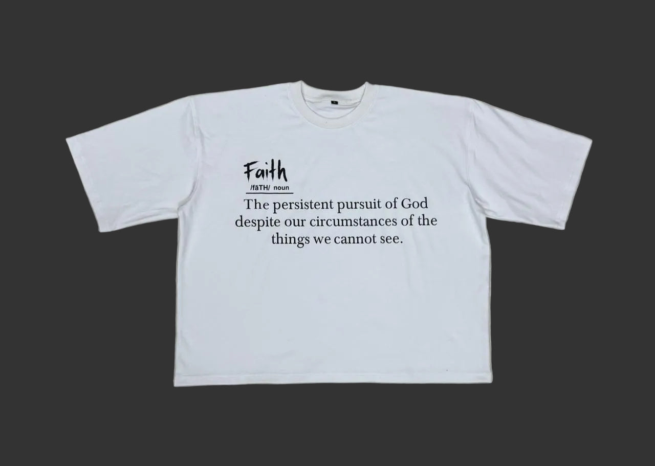 White t shirt explaining the definition of faith. Faith is pursuing God and trusting he is in control of the things we cannot see. 